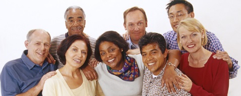 Group of diverse adults with their arms around each other, smiling
